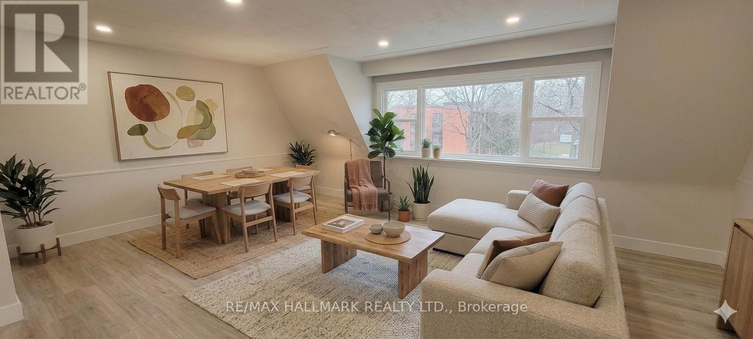 A living room with a couch, a table, and a painting on the wall.