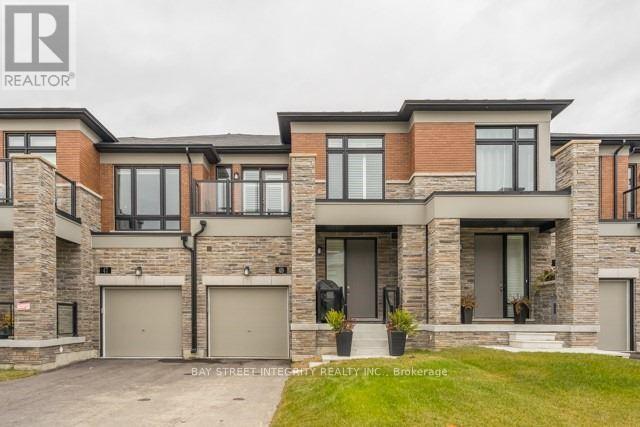A modern house with a brick facade and a large front yard.
