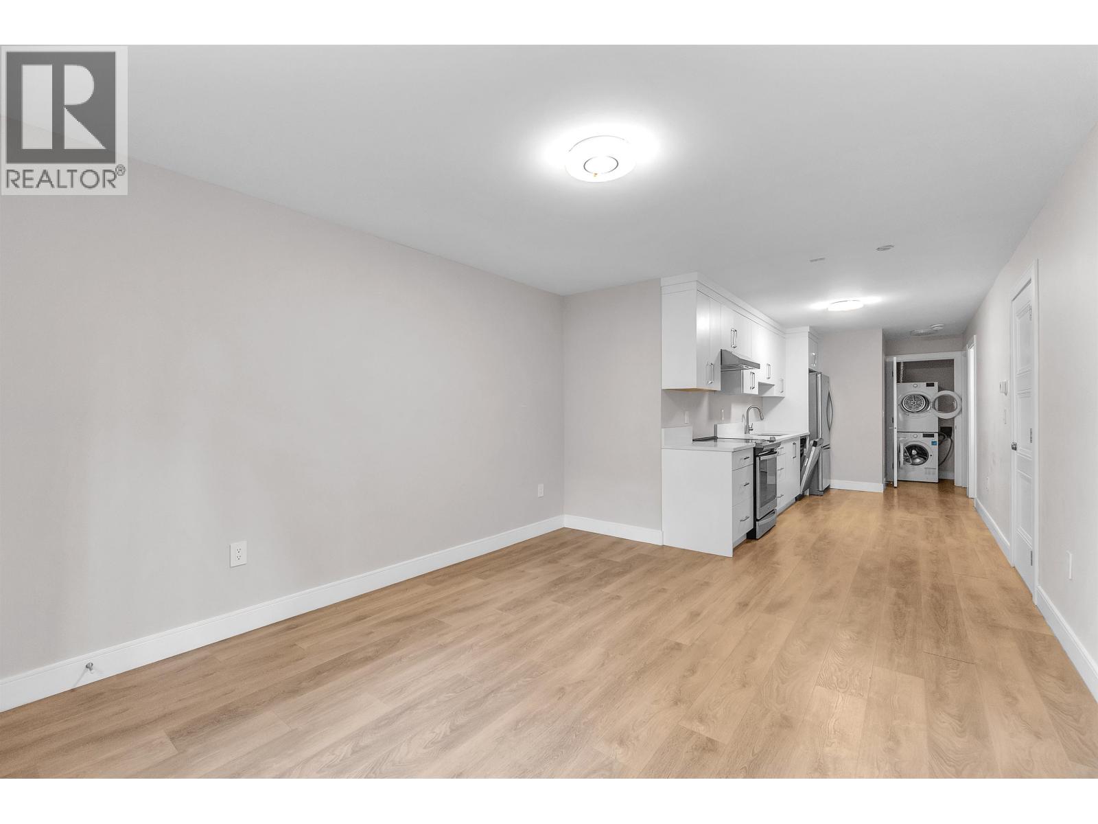 A kitchen with a table and chairs in the middle of the room.