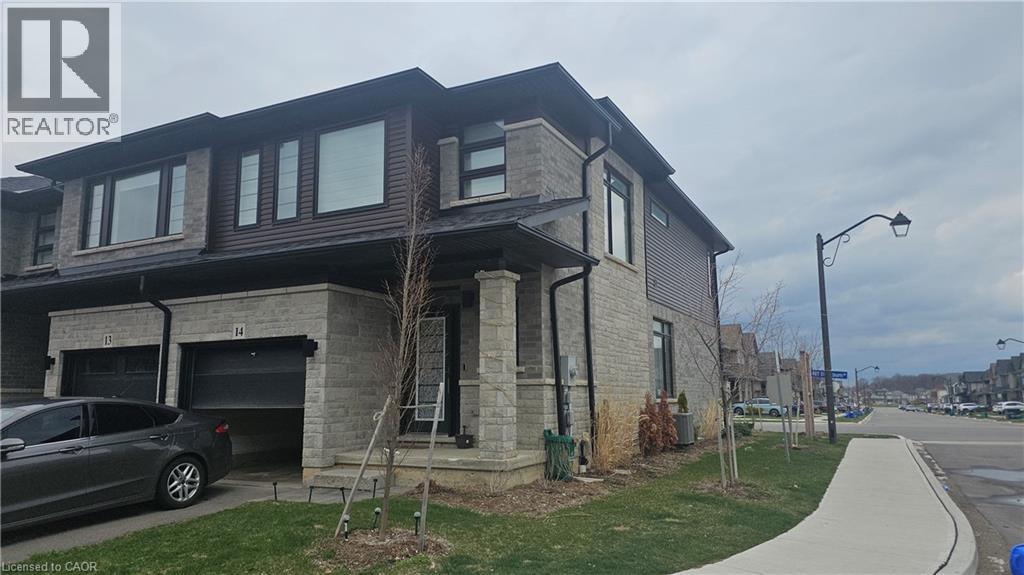 A grey house with a car parked in front.