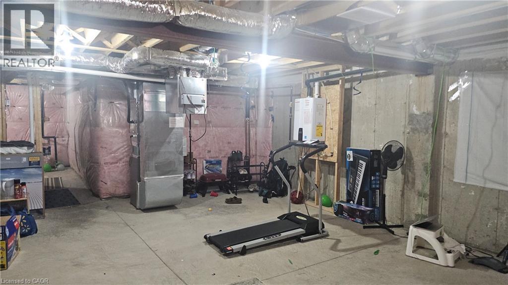 A gym with a treadmill, weights, and exercise equipment.