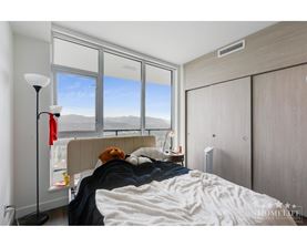 A bedroom with a large bed and a window overlooking the mountains.