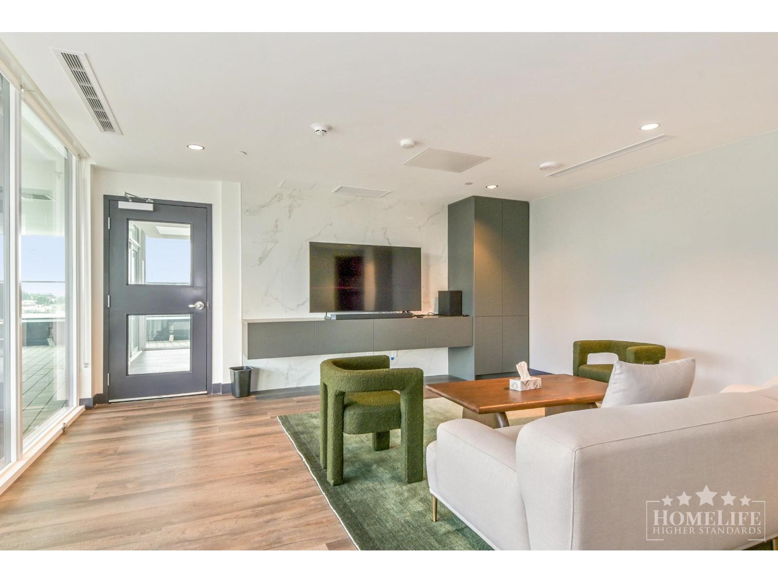 A modern living room with a white sofa, green armchair, and a wooden coffee table.