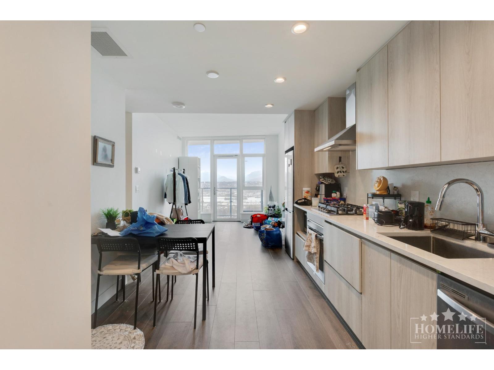 A kitchen with a dining table and chairs is shown.