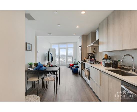 A kitchen with a dining table and chairs is shown.