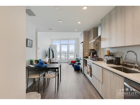 A kitchen with a dining table and chairs is shown.