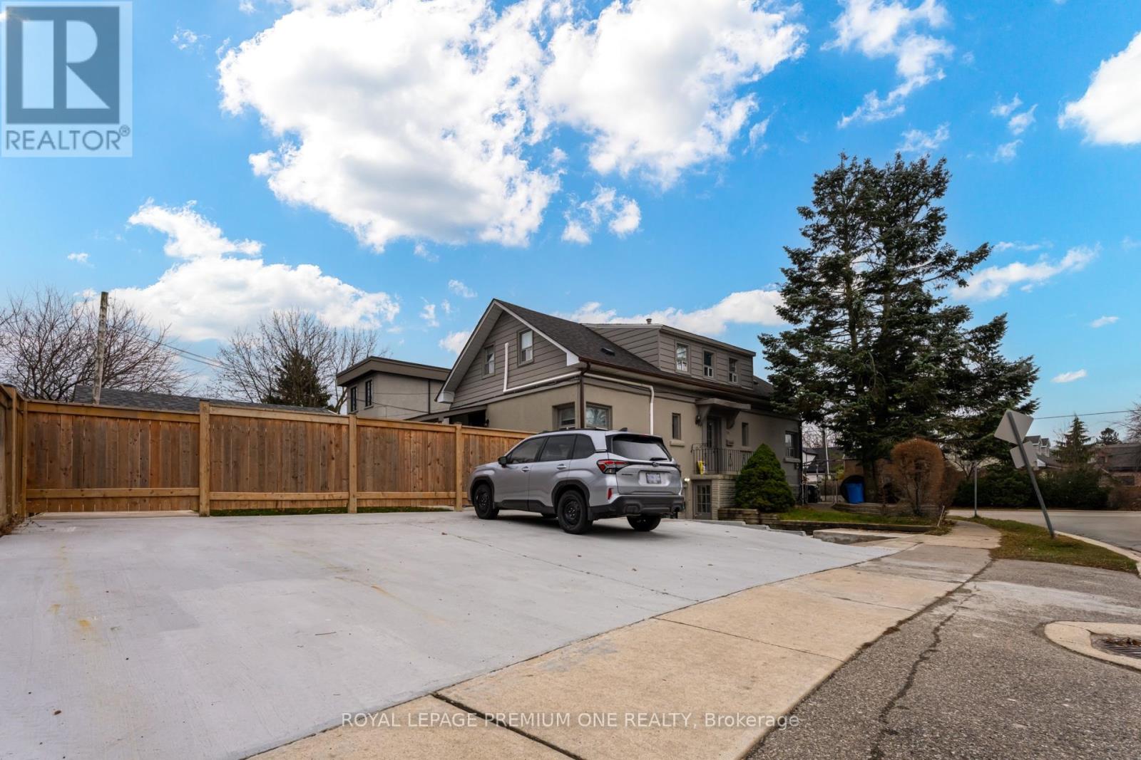 A house with a garage and a car parked in front.