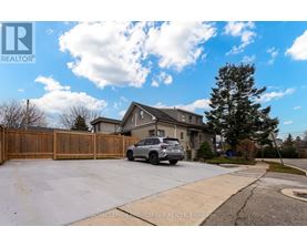 A house with a garage and a car parked in front.