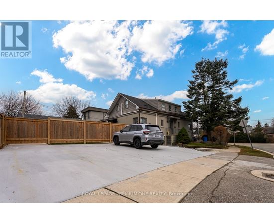 A house with a garage and a car parked in front.