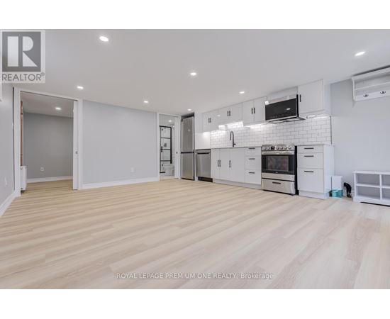 A spacious kitchen with white cabinets and appliances.