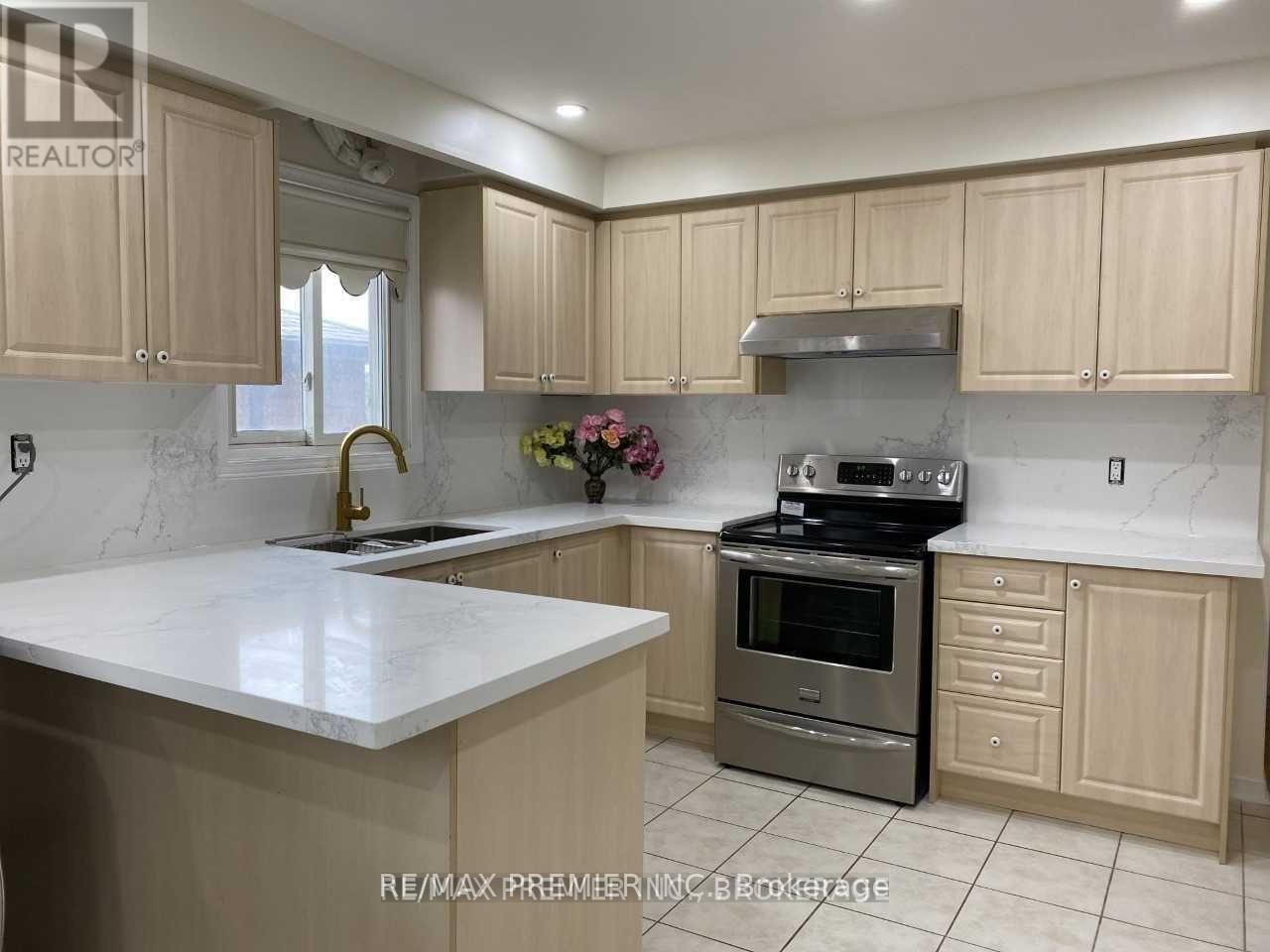 A kitchen with a white counter top and wooden cabinets.