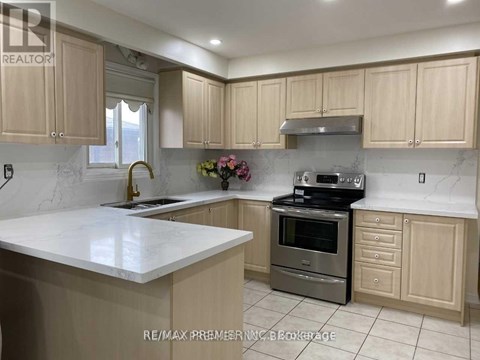 A kitchen with a white counter top and wooden cabinets.