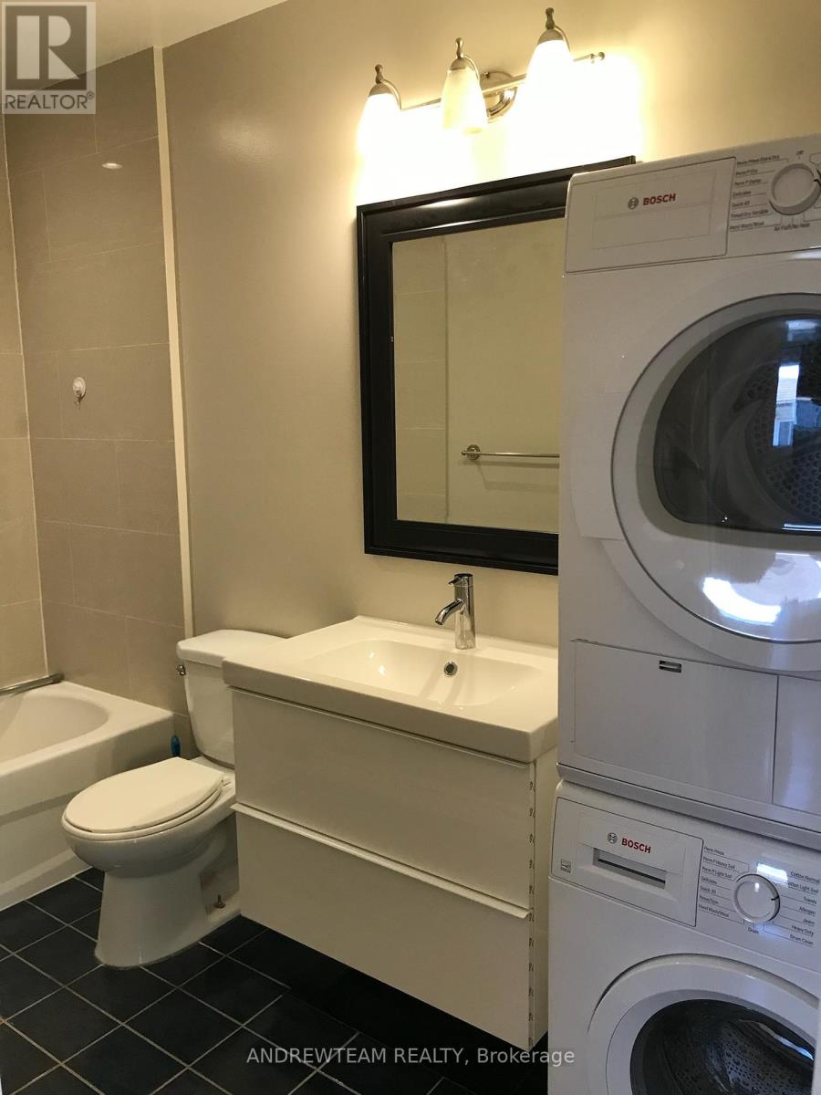 A bathroom with a washer and dryer in it.