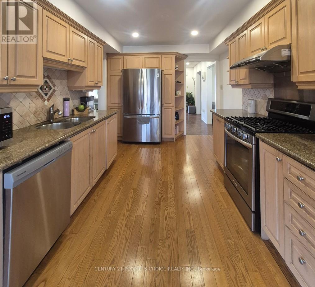 A kitchen with wooden cabinets and stainless steel appliances.