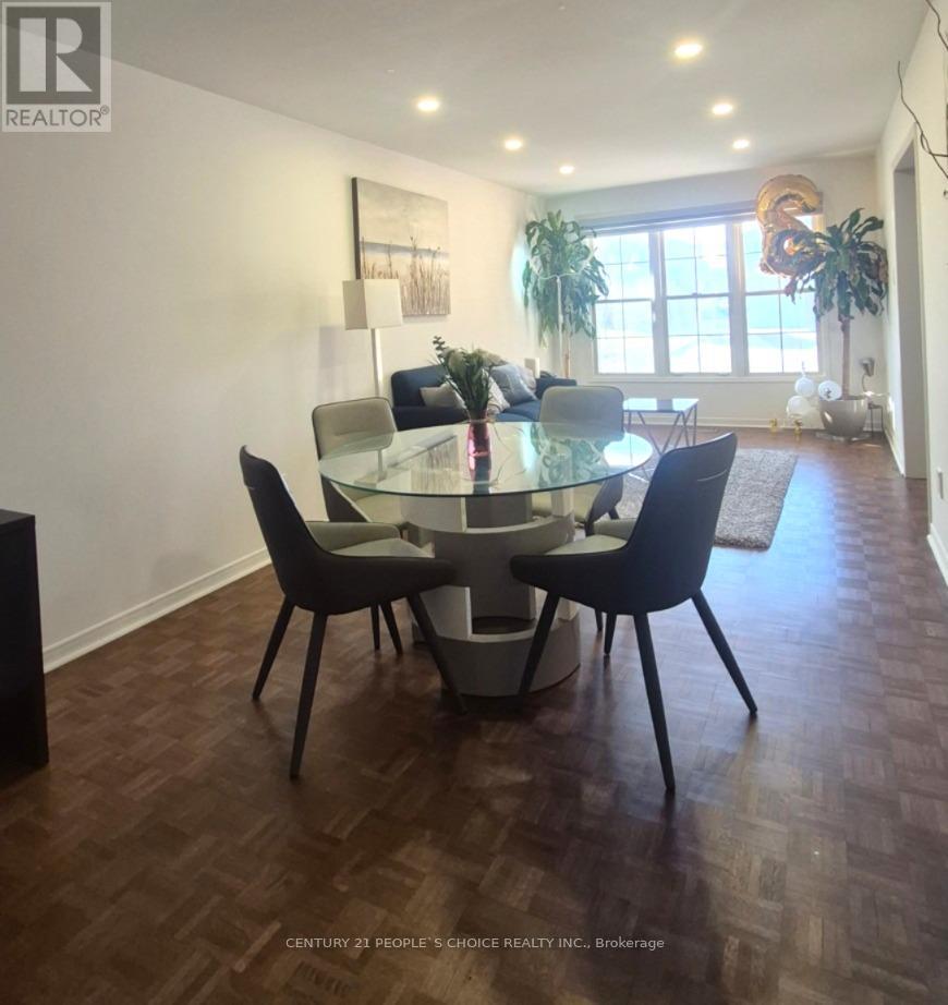 A modern dining room with a glass table and chairs.
