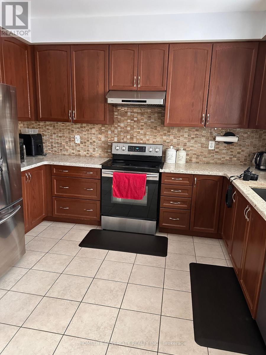 A kitchen with a stove top oven and a refrigerator.