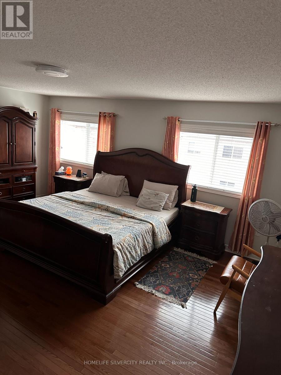 A bedroom with a large bed and wooden furniture.