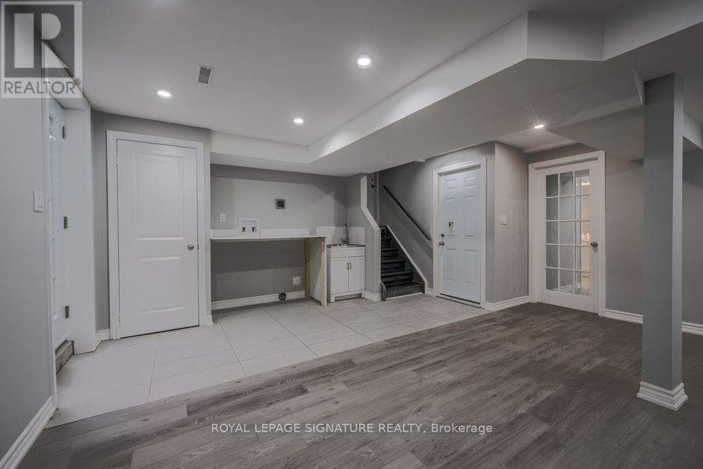 A spacious room with a staircase and a dining area.