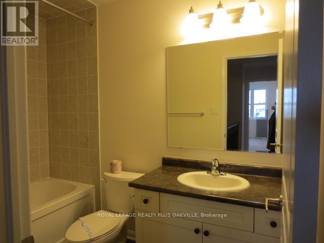 A bathroom with a sink, toilet and bathtub.
