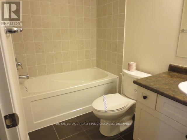 A white toilet with a white seat cover in a bathroom.