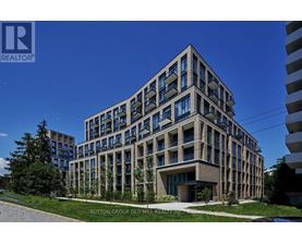 A modern building with a glass facade is the main focus of the image.