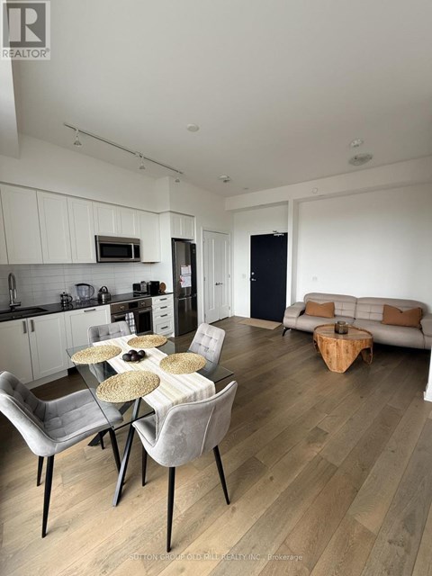A modern kitchen with a dining table set for four.
