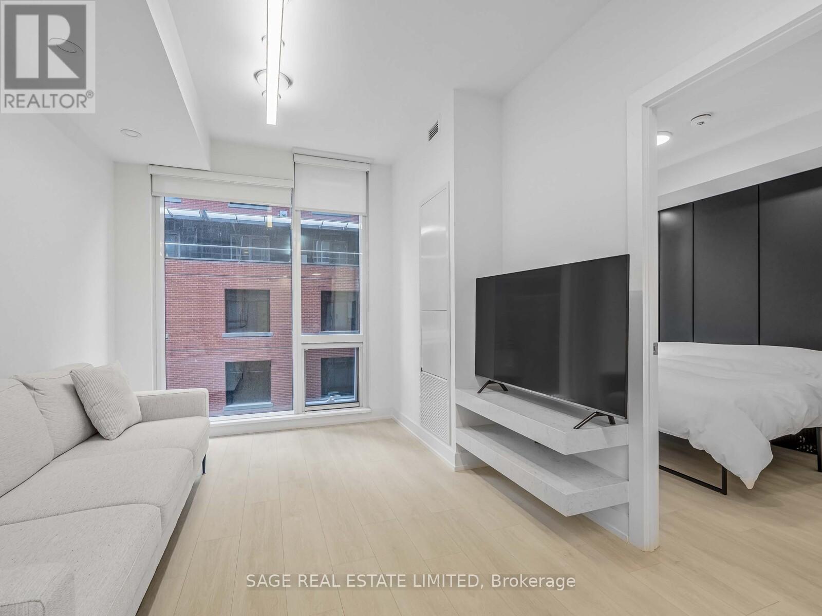 A modern living room with a large window and a flat screen TV.