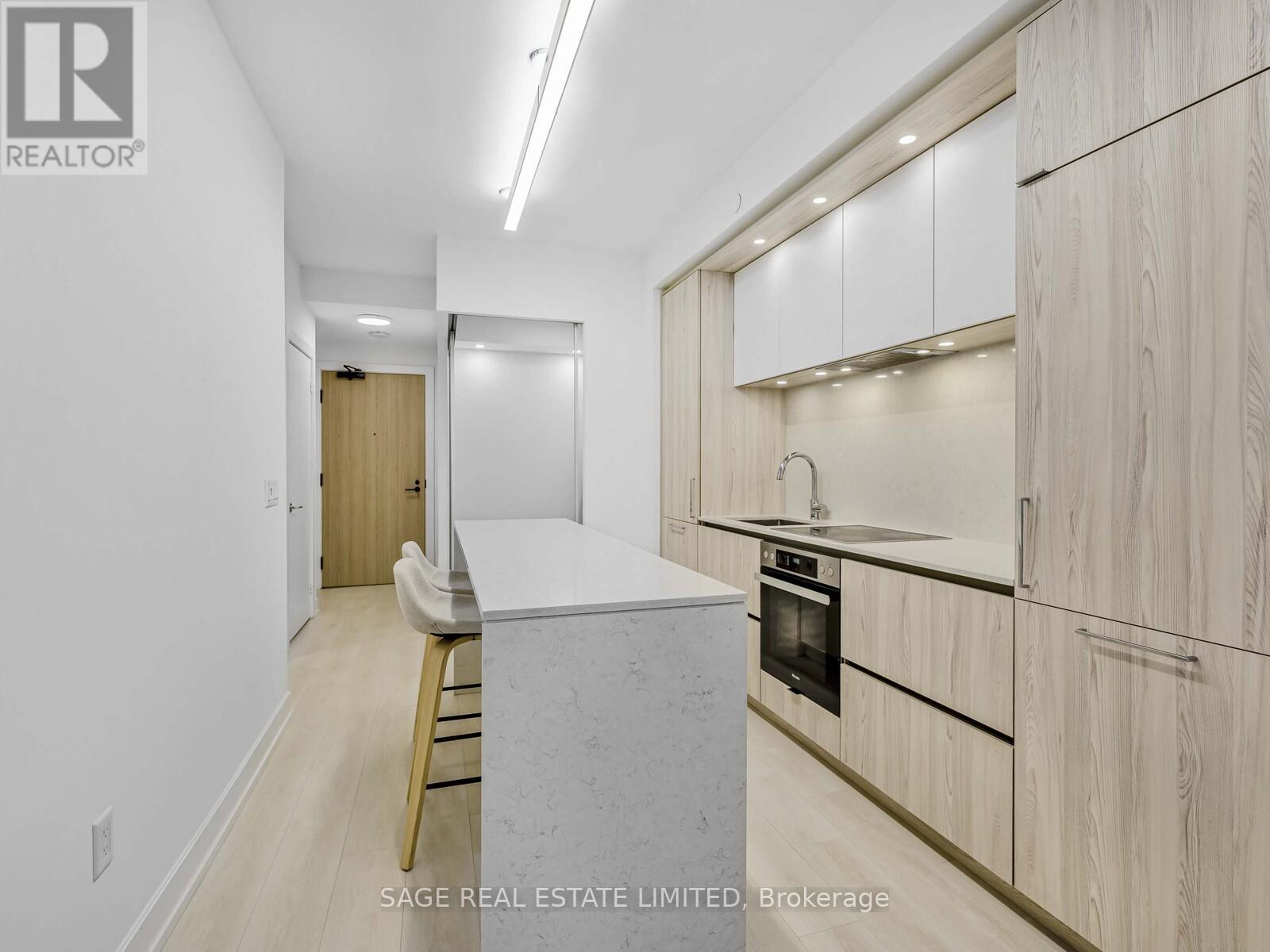 A kitchen with a white counter top and wooden cabinets.