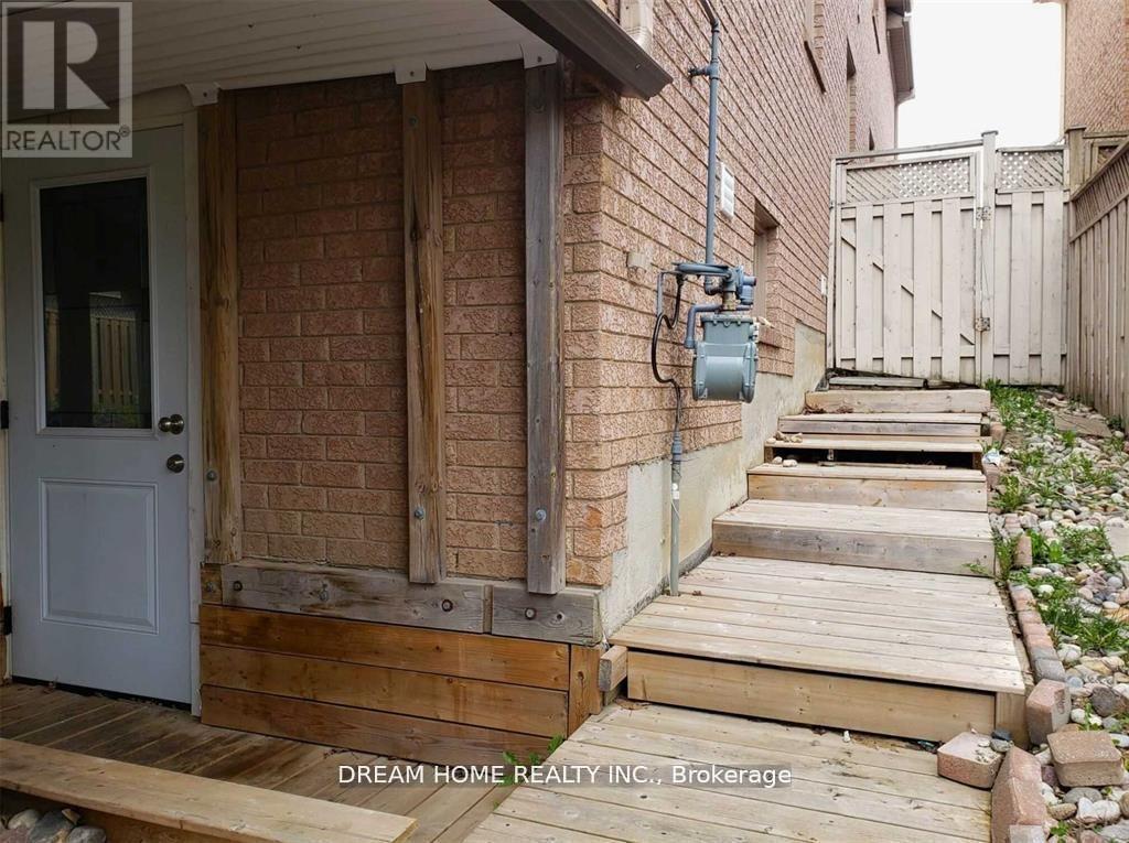 A house with a white door and wooden steps leading to it.