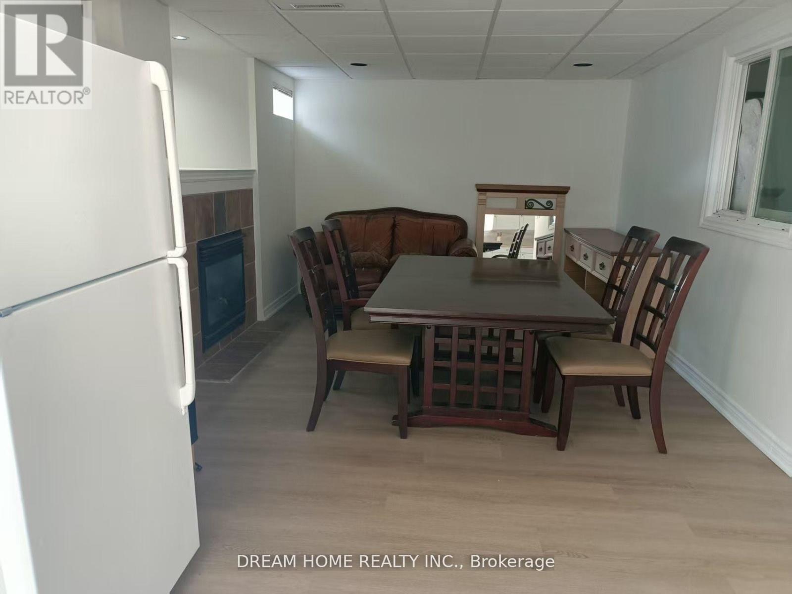 A kitchen with a table and chairs in the middle of the room.