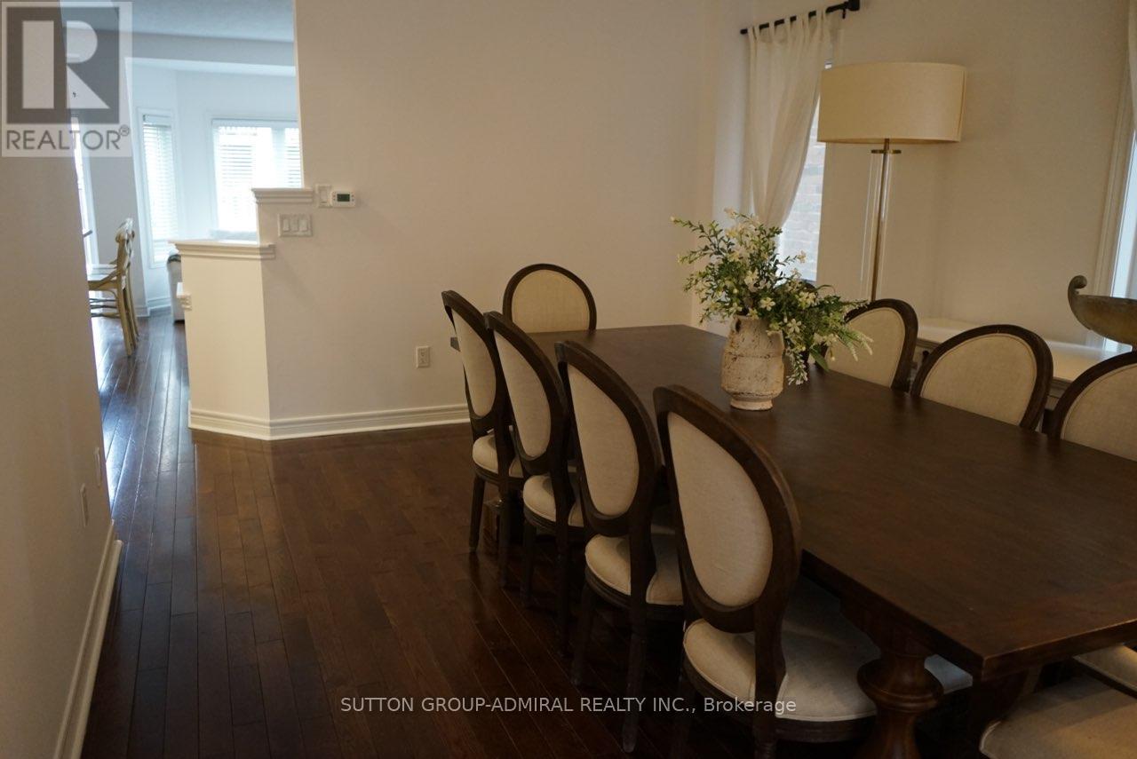 A dining room with a wooden table and chairs.