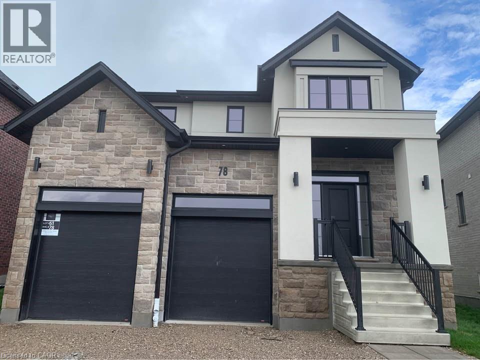 A house with a stone facade and two garage doors.