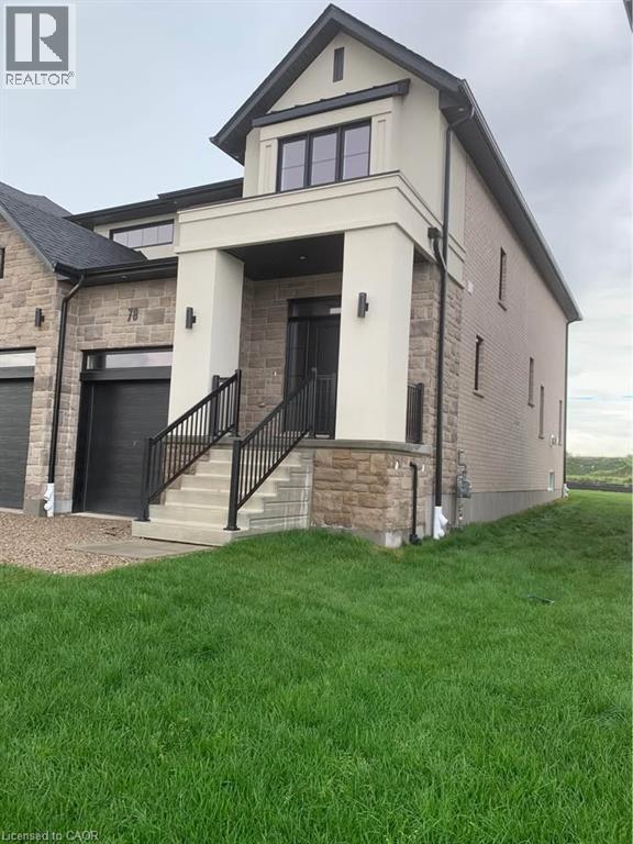 A house with a black door and a balcony with a black railing.