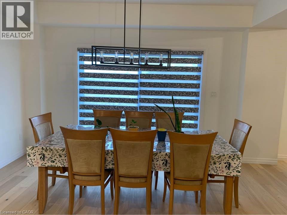 A dining room with a table and chairs.