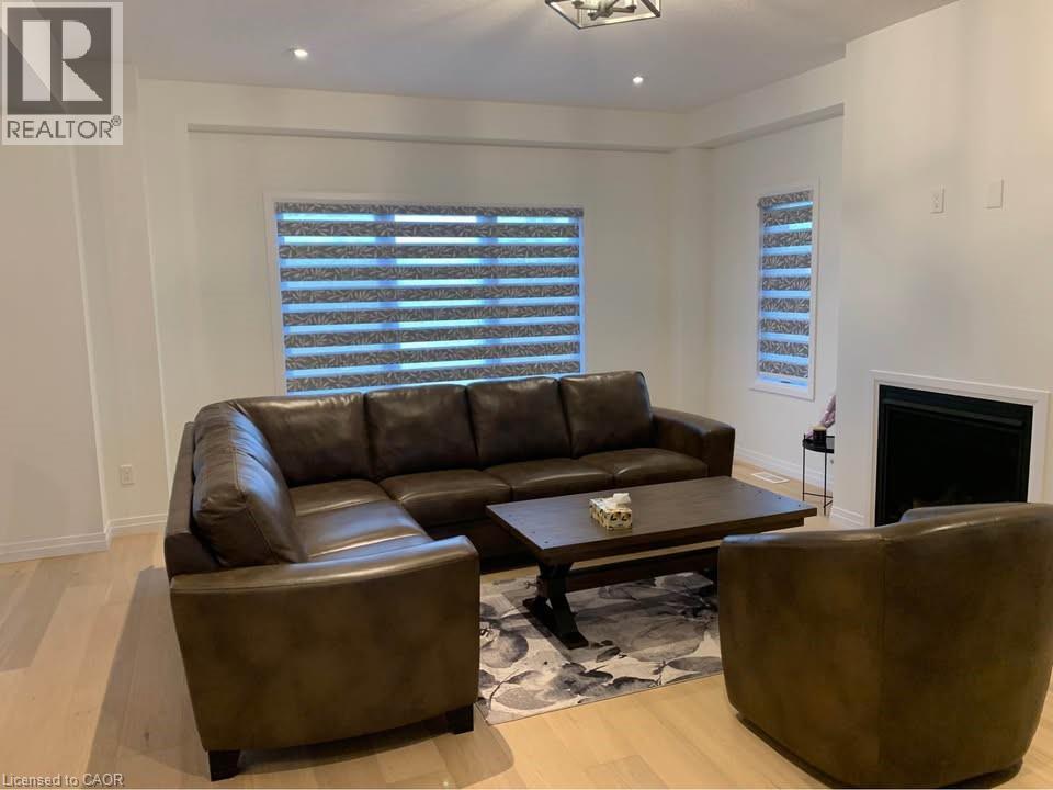 A living room with a brown leather couch, a brown armchair, and a coffee table.