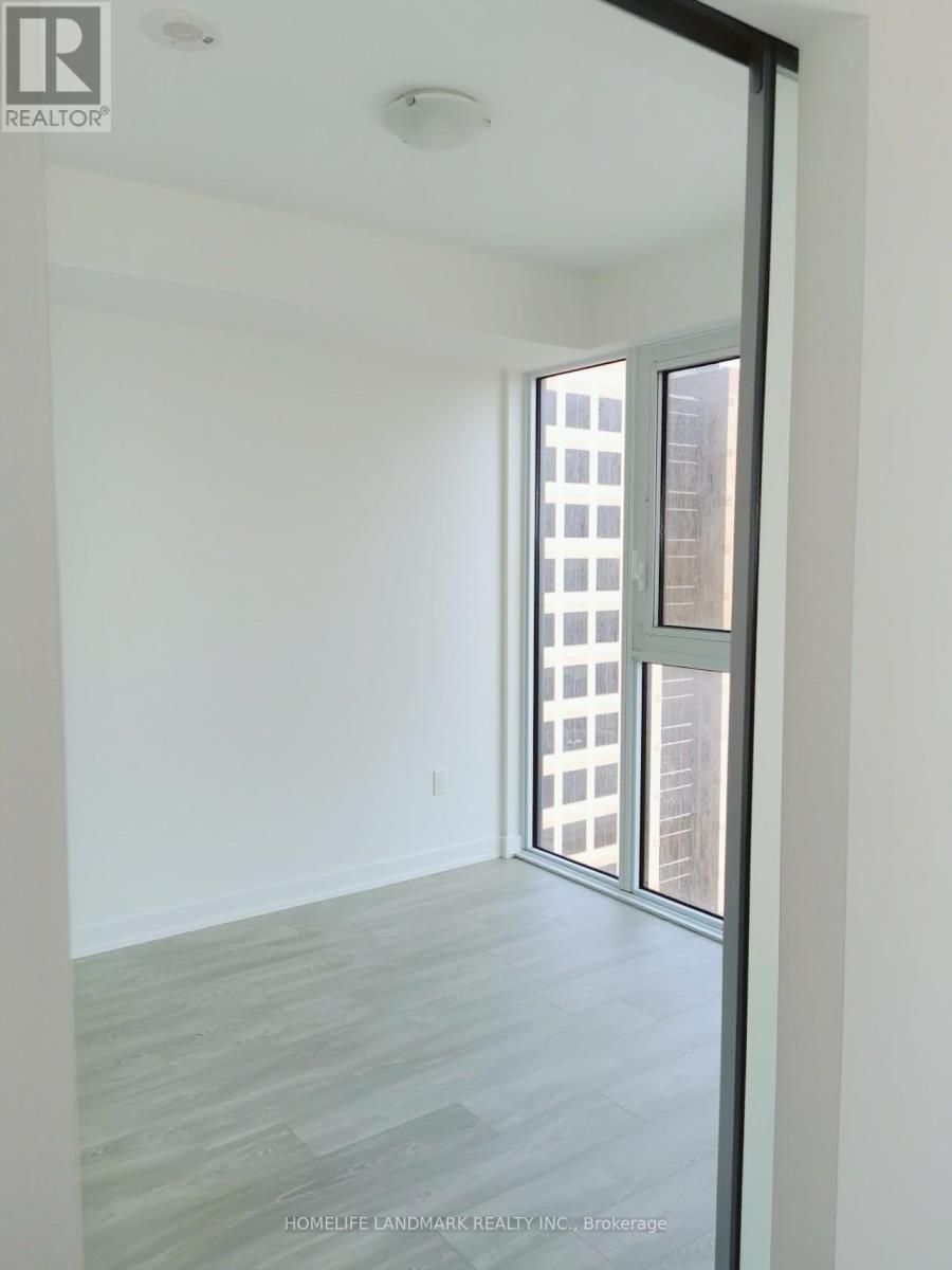 A room with a sliding glass door leading to a balcony.