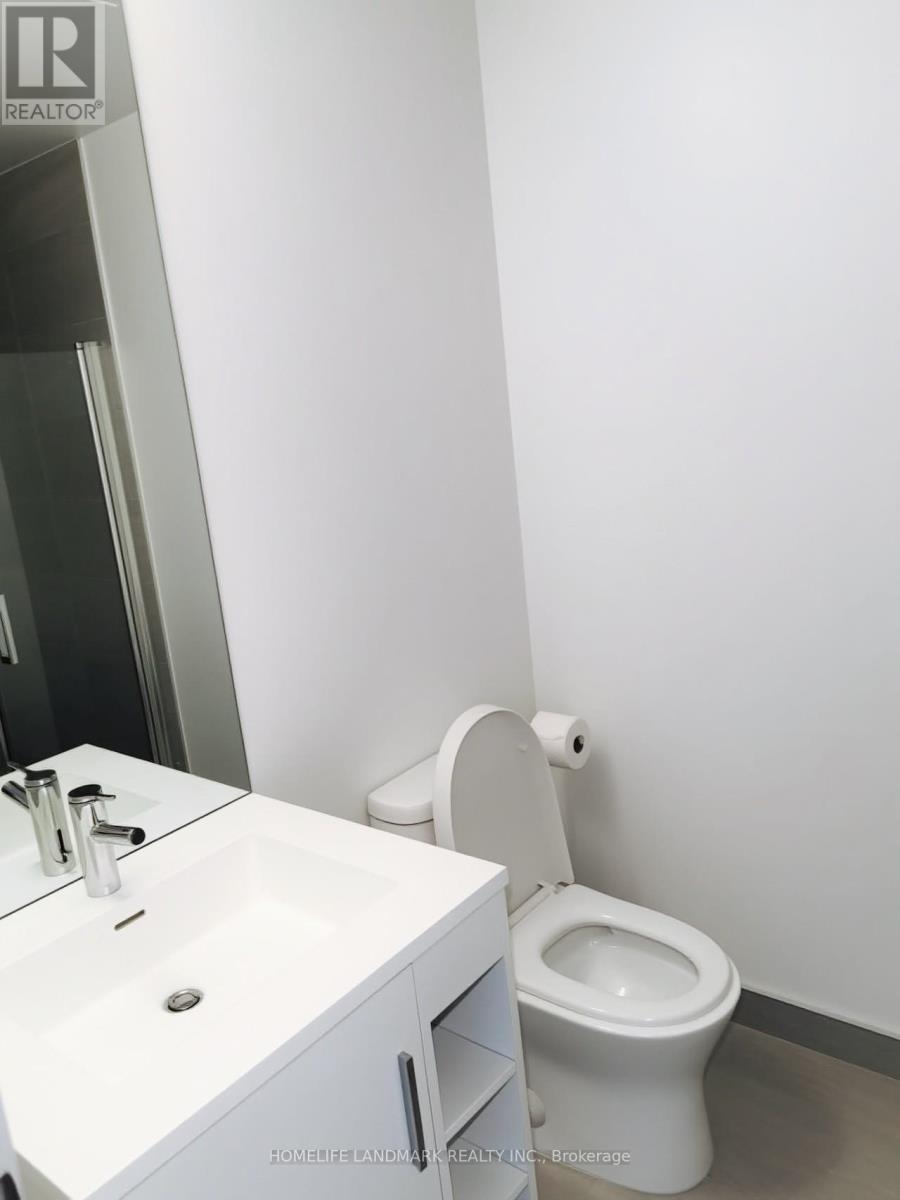 A white toilet sits next to a sink in a bathroom.
