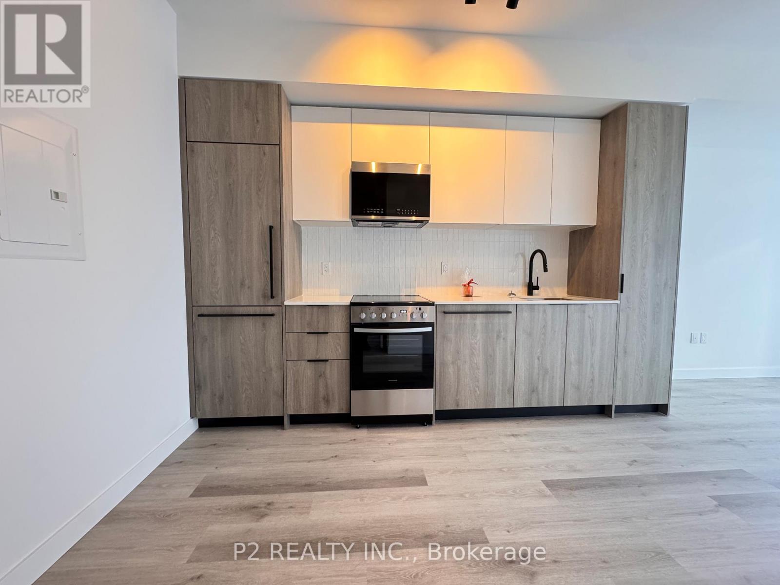 A modern kitchen with wooden cabinets and a stainless steel oven.