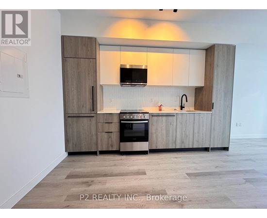 A modern kitchen with wooden cabinets and a stainless steel oven.