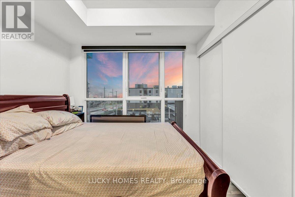 A bedroom with a large bed and a view of the city through the window.