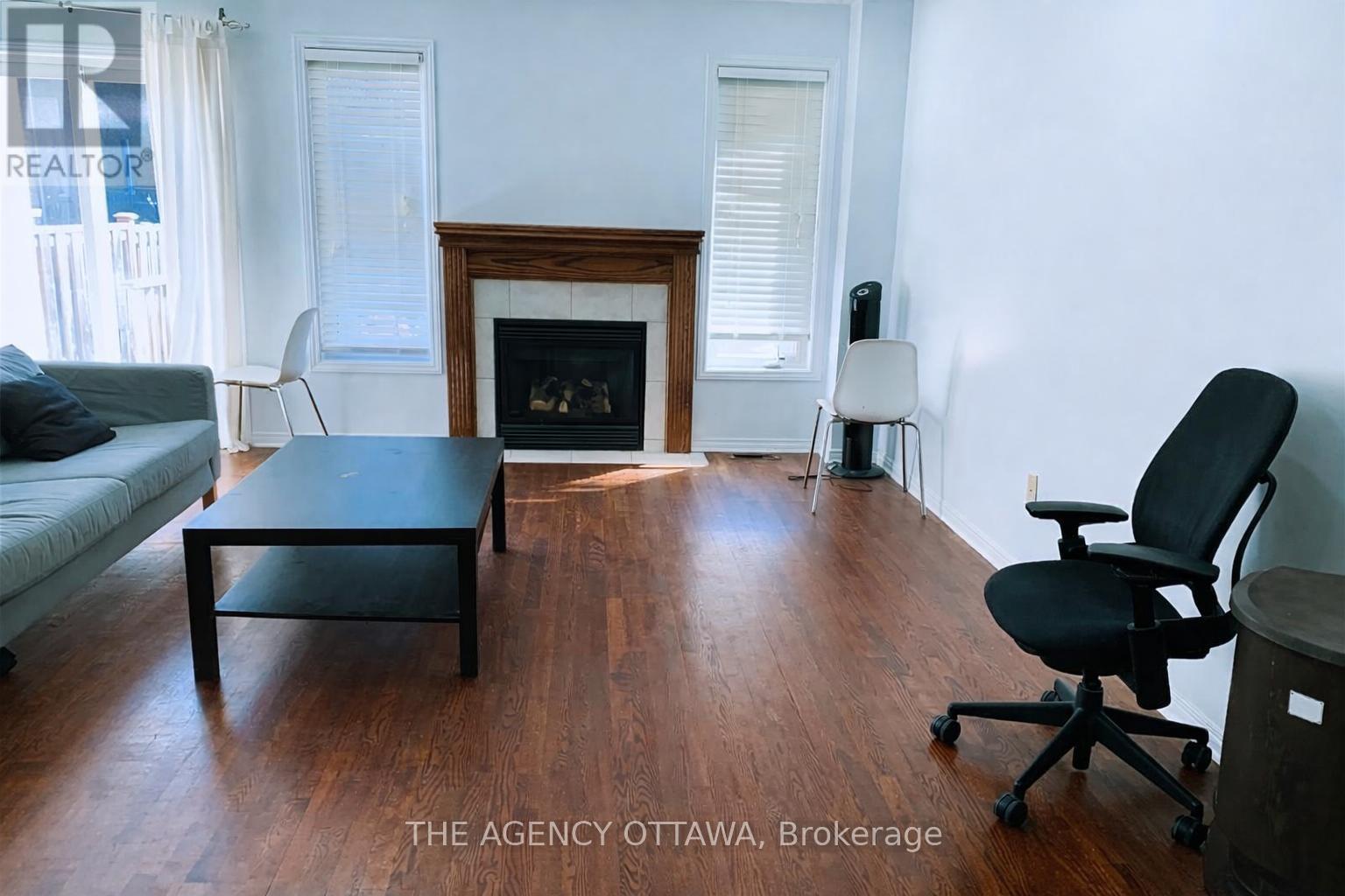 A living room with a fireplace and a chair.