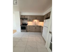 A kitchen with a white fridge and wooden cabinets.