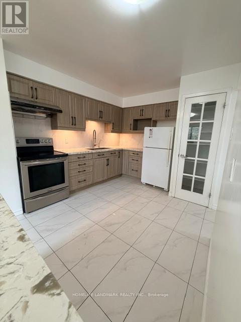 A kitchen with a white refrigerator and wooden cabinets.