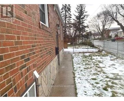 A brick house with a snow covered ground.