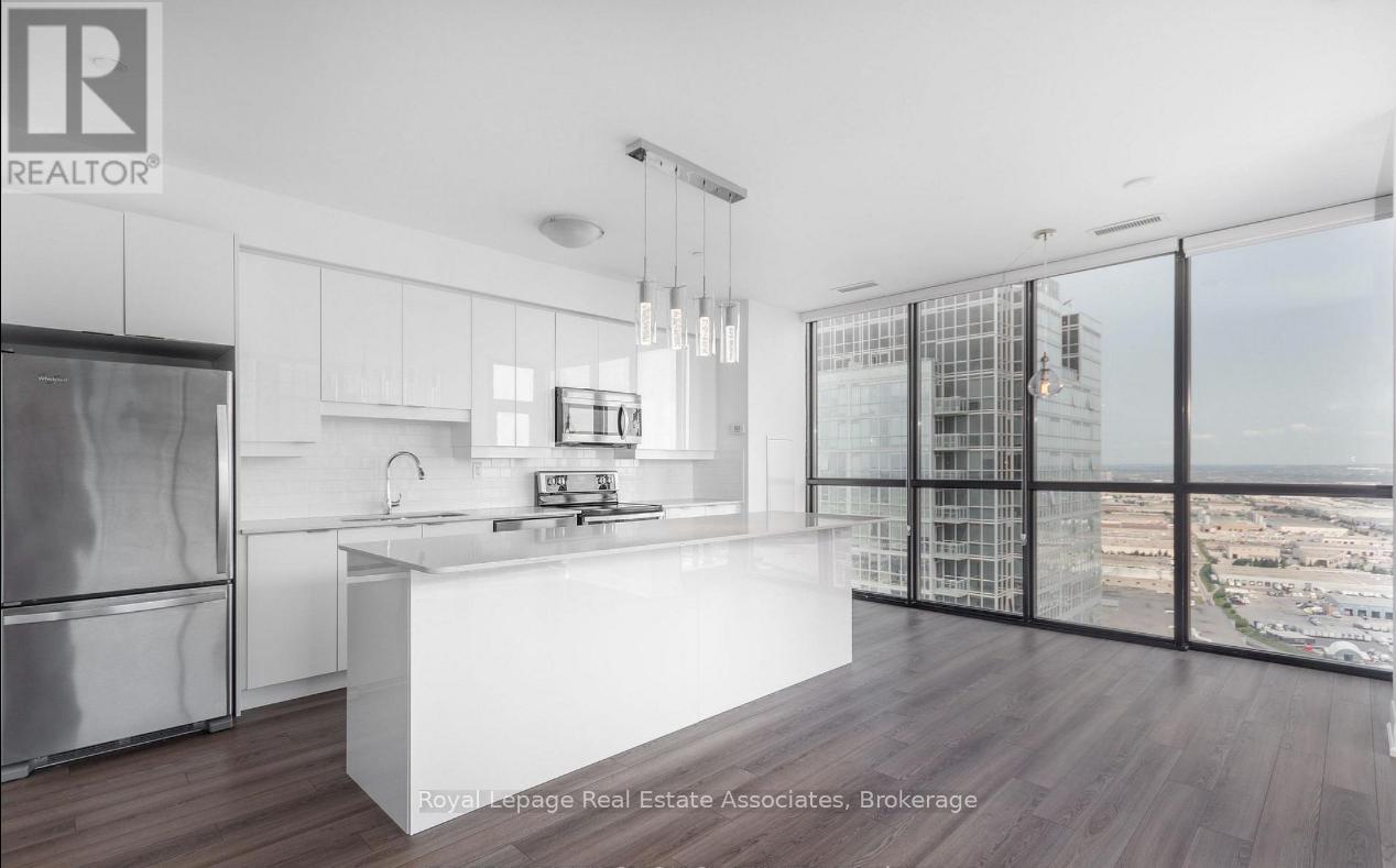 A modern kitchen with a view of the cityscape outside the window.