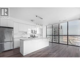 A modern kitchen with a view of the cityscape outside the window.