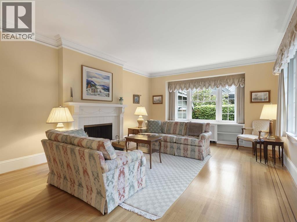 A living room with a couch, chair, and fireplace.