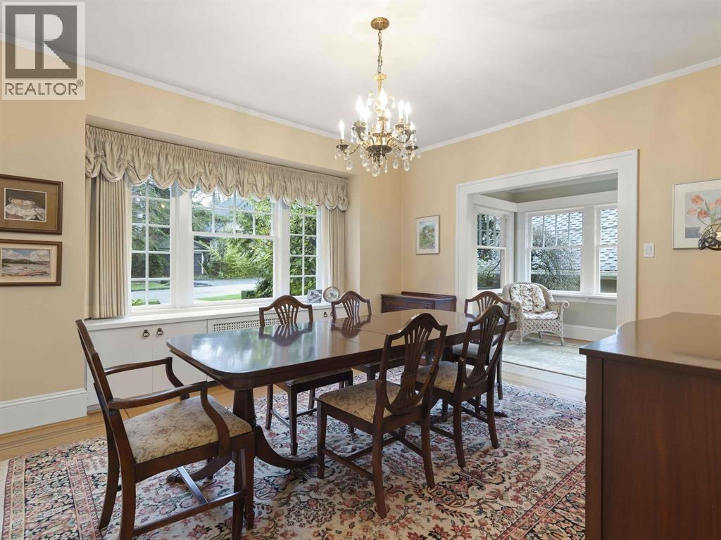A dining room with a table set for six.