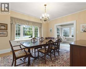 A dining room with a table set for six.