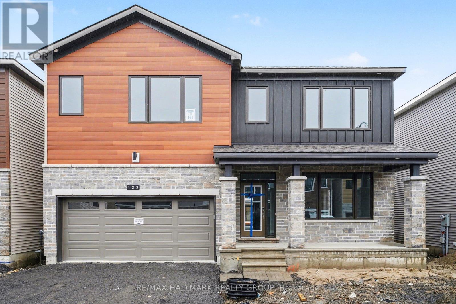 A modern two-story house with a garage.